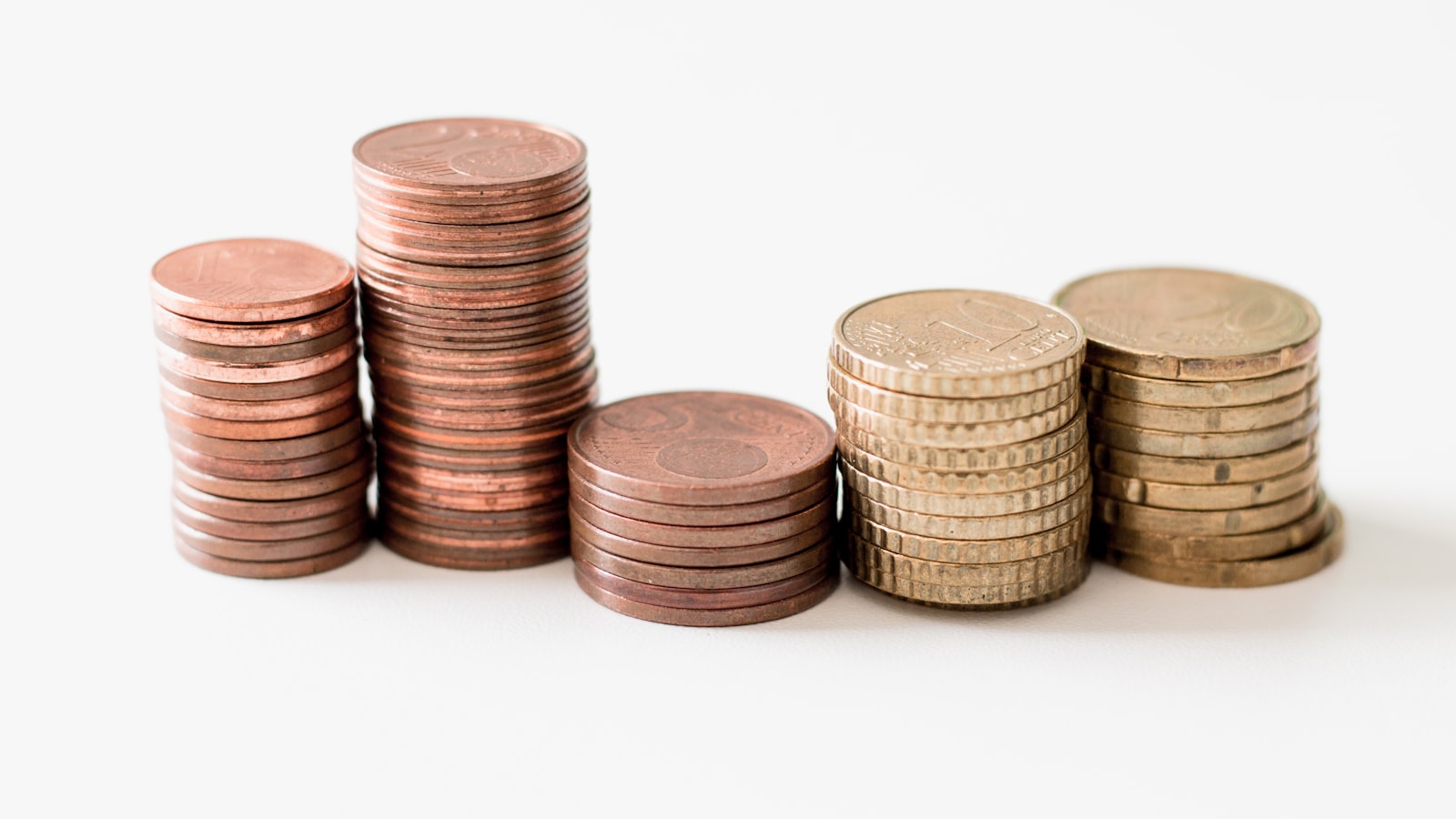 Uneven stacks of coins representing AI gross margin, token costs and MRR