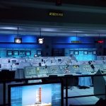 Mission control command center room with rows of consoles, representing a customer support operations command center